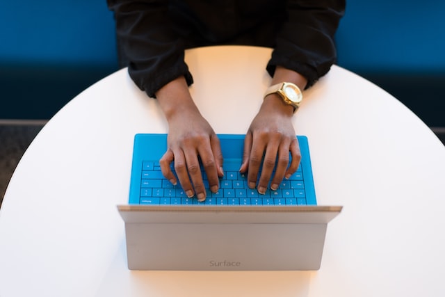 Woman typing on tablet while watching interactive training video